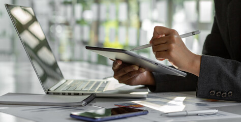 Close up of Accounting businesswoman working on note laptop computer and analyzing real estate investment data, Financial and tax systems concept.