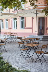 table and chairs on the terrace empty street cafe with garden