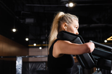 side view of handicapped sportswoman working out on exercise machine