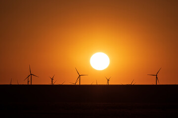 wind turbines at sunset