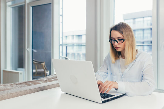 Young Beautiful Woman Freelancer Tired Working At Night On A Laptop, Completes Work Late