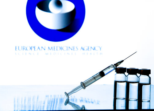 Syringe and vials with covid-19 vaccine on white background