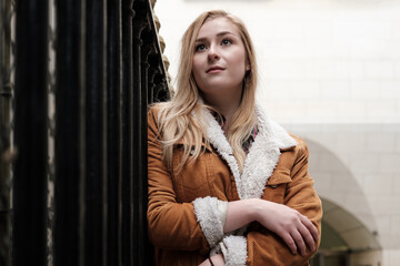 Fototapeta premium Young blonde woman posing in an urban environment.