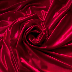 red satin background with rose shape