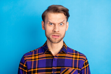 Portrait of impressed unsatisfied person frowned eyebrows look camera isolated on blue color background