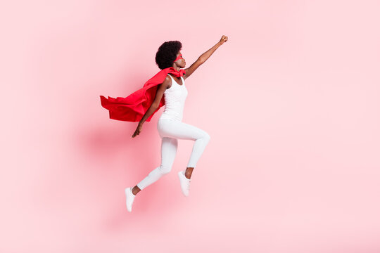 Full length body size view of active slim motivated wavy-haired girl jumping striving isolated on pink pastel color background