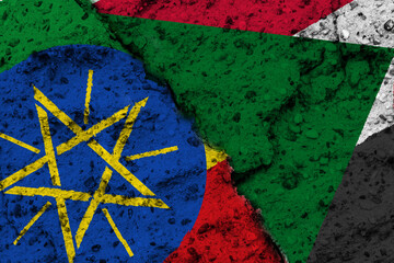 Concept of a Conflict between Ethiopia and Sudan with painted flags on a rough wall with cracks