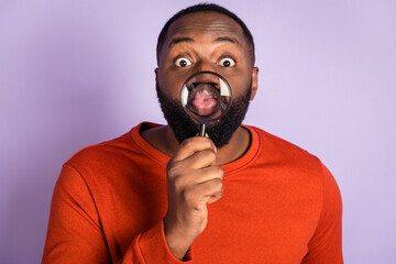Portrait of attractive funky foolish guy having fun using loupe pout lips isolated over violet...