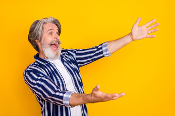 Photo of happy excited crazy smiling mature man look copyspace with open hands hug embrace isolated on yellow color background