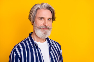 Photo of handsome attractive mature businessman with beard and mustache isolated on yellow color background