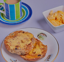 Buttered tea cakes with cup of tea.