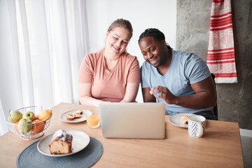 Couple having call with relatives after eating cake and drinking juice