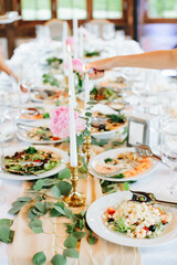 
Burning candles oт festive table. Preparation for festive dinner, food service. Selective focus.