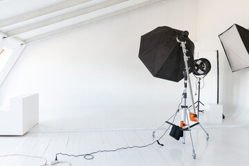 Empty photo studio with lighting equipment. Photographer workplace interior with professional tool...