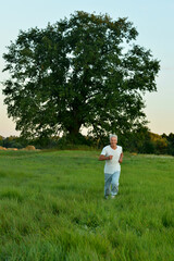 Naklejka premium Happy man running in summer field