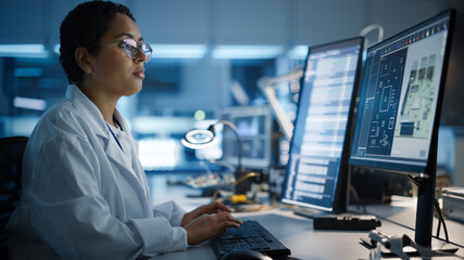 Modern Electronics Development Facility: Female Engineer Works on Computer with CAD Programming...