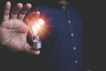 Innovation design forms an inspiration concept. Businessman holding lightbulb symbol creative idea...