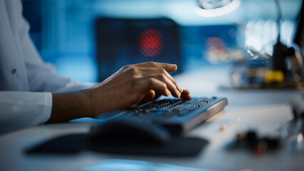 Modern Electronics Research, Development Facility: Engineer Working on Computer, Typing with His Hands on a Keyboard. Scientist Design PCB, Silicon Microchips, Semiconductors. Close-up Focus on Hands 