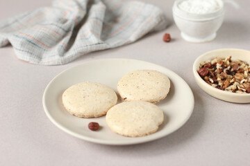 Delicious homemade nut cookies, in warm beige tones, round cookies on a plate