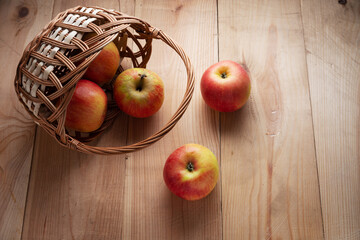 Large ripe apples in a wicker basket.