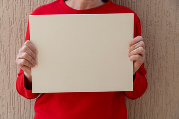 woman in red blouse holding white sign