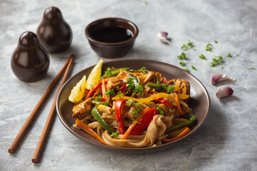 Rice noodles with chicken, soy and vegetables, asian cuisine.