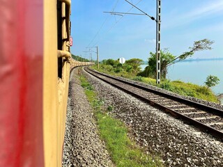 railway in the countryside near a lake.