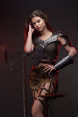 Fototapeta premium Studio shot of wild woman viking holding axe