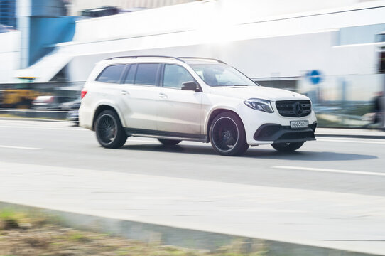 Mercedes GL Class X166 In The City Street. Urban Scene With Vehicle Riding Fast And Blurred Background. Side View Of Premium German SUV In Motion