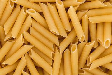 Close up photo of raw penne rigate pasta. Top view high resolution macro photo.