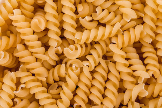 Close up photo of raw pasta fusilli. Top view high resolution macro photo.