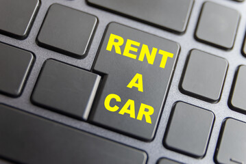 Black pc keyboard, with "Rent a car" text. Online booking of a rental car. 