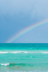 Rainbow on a cloudy day at the beach
