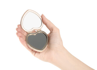 Woman holding stylish heart shaped cosmetic pocket mirror on white background, closeup