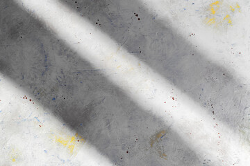 Gray plastered concrete vintage wall with two lines of shadow. Grey toned stone backdrop with yellow spots.