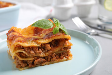 Tasty cooked lasagna served on grey table, closeup