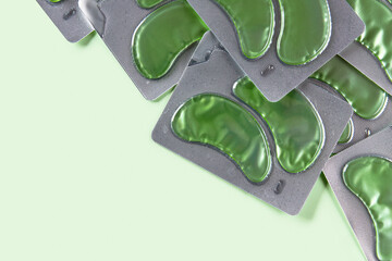 Eye patches set over green backgound. Face care beauty treatment concept