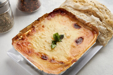 lasagna accompanied by strips of bread