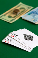 poker.four of a aces, quads in casino. playing cards with blue deck on the green table. combination of cards on a green casino desk background.copy space. vertical