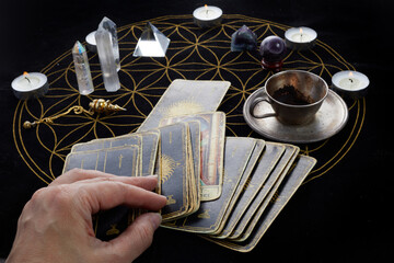 Fortune Telling Table with tarot cards and esoteric objects. Fortune-teller guessing from tarot - obrazy, fototapety, plakaty