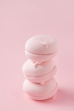 Stack Of Round Pink Marshmallows On Pastel Pink Background, Close-up. Three Sweet Zephyr Candies For Postcard.