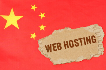 Against the background of the Chinese flag lies cardboard with the inscription - Web Hosting