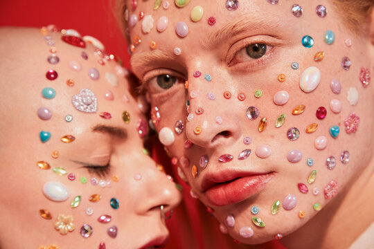 Albino Boy With Decor At His Face Looking At The Camera While Bonding To The Mannish Bald Female