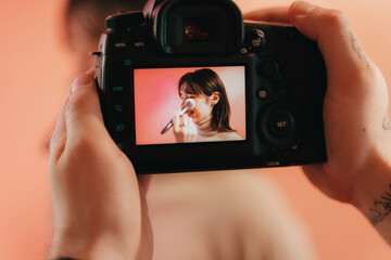 Woman smiling while stylist checking her makeup during the shooting