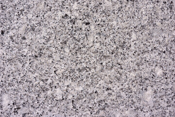 Close view of the smooth surface of a cut granite boulder.