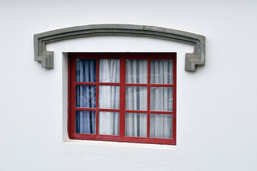 Single Window with Brown Wooden Frame  in White Stucco Wall
