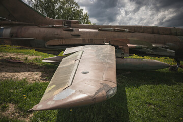 wing of an old vintage war airplane, cloudy spring day, young grass under the plane