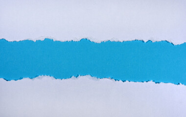 Ripped in white paper on blue background
