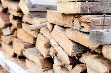 The end of a wooden board. Saw cut a cut. A stack of boards. Building materials