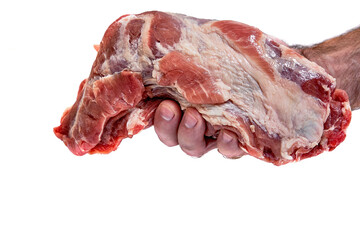 There a human hand holds a large piece of raw pork neck isolated on a white background with a copy of the space